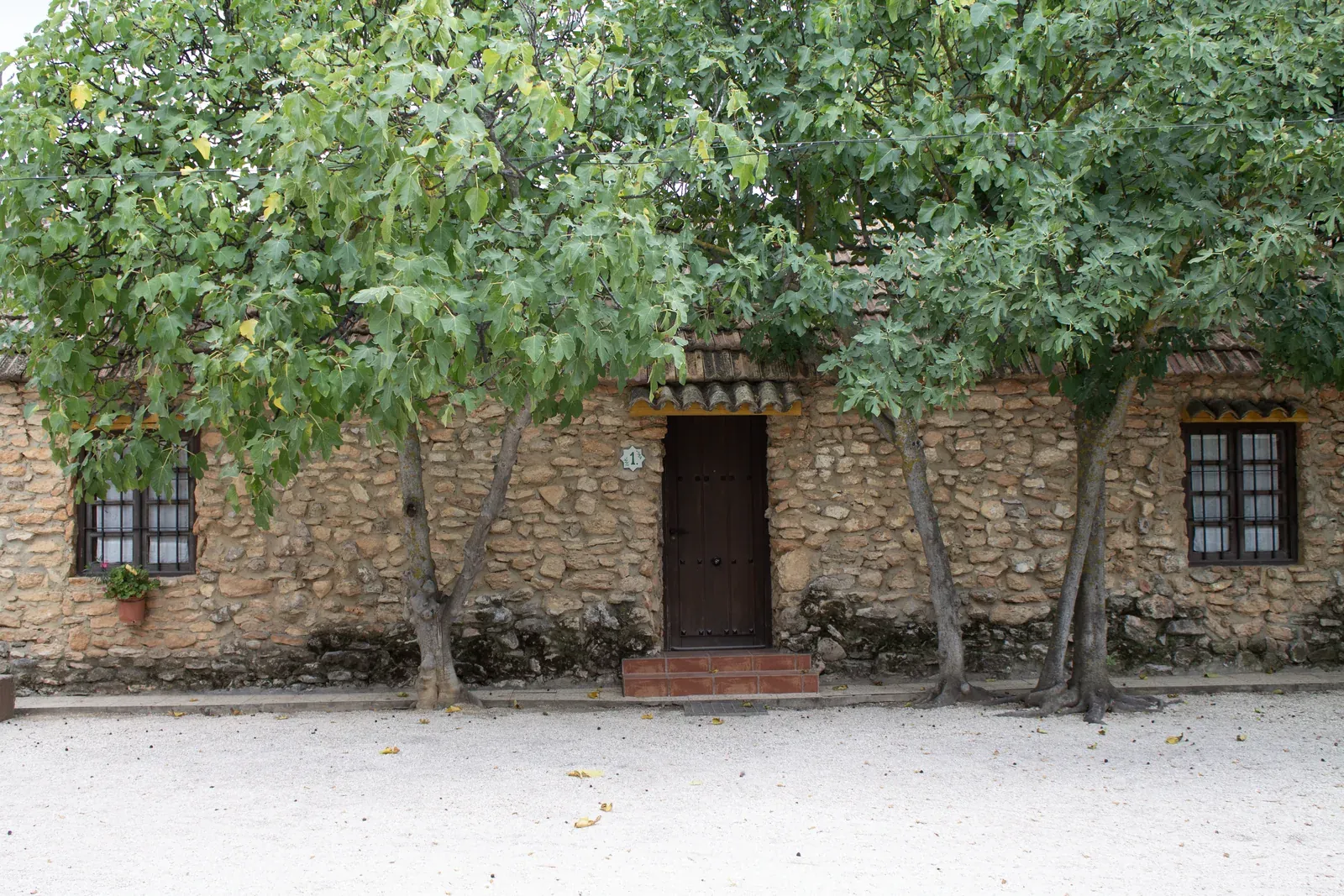 The stone facade of the cortijo.