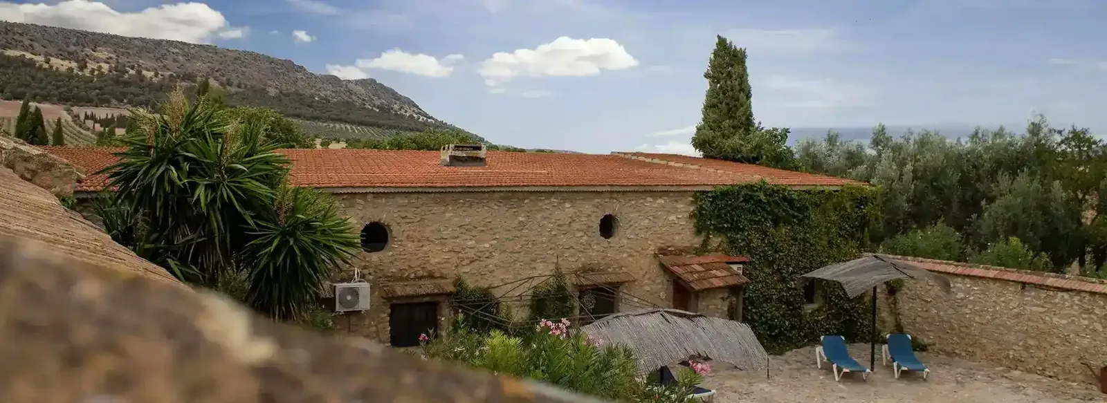 The house with the Andalusian mountains behind it