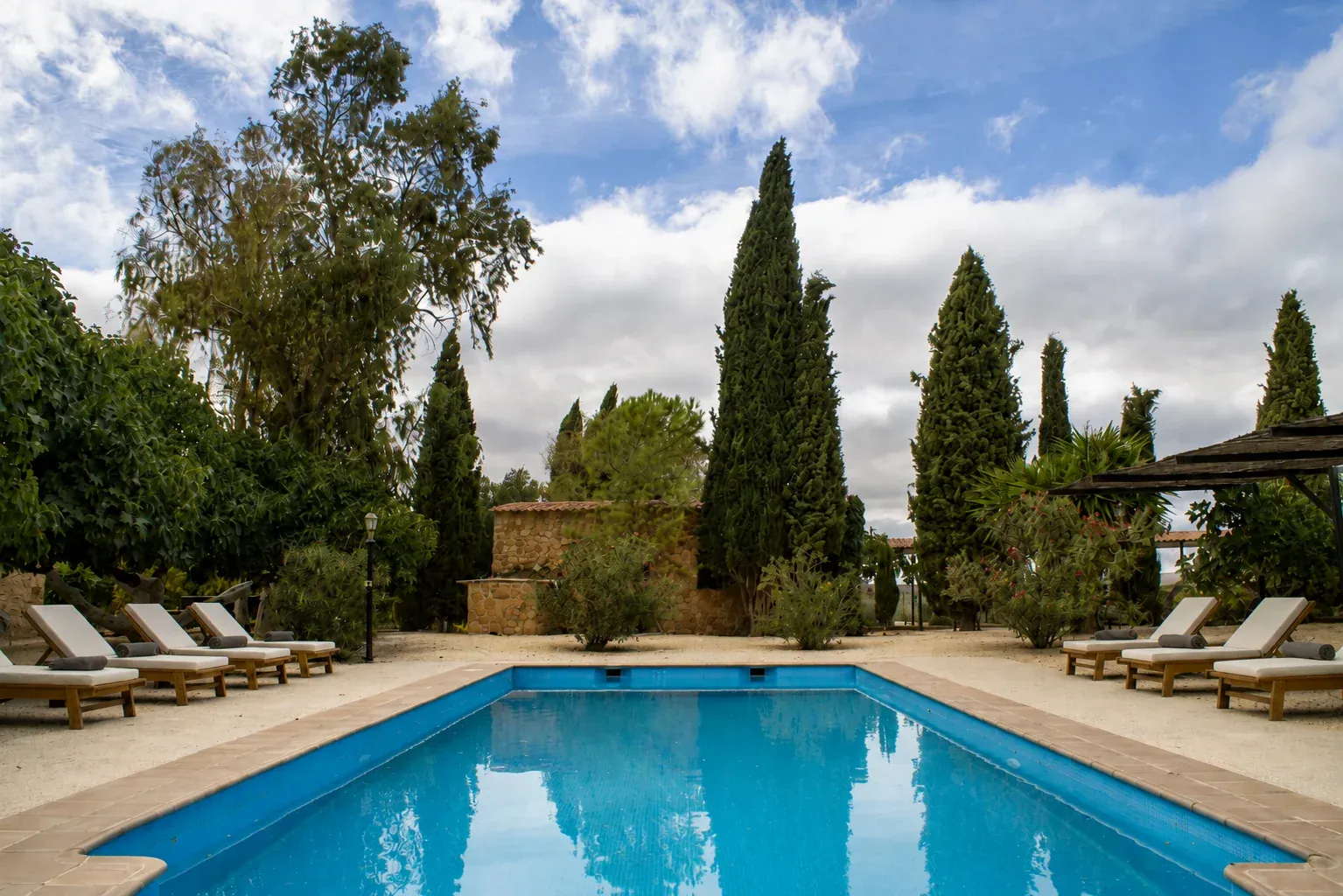 Loungers beside the pool and terrace at Sierra Recovery, Humilladero, Malaga.